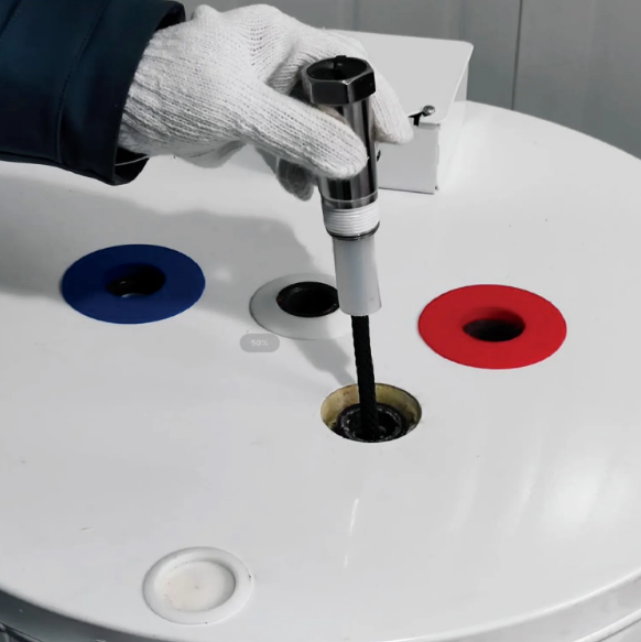 Person installing a powered anode rod in a water heater