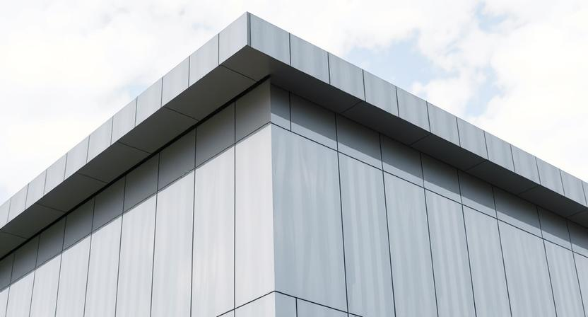 A modern building facade or roof made with titanium panels.